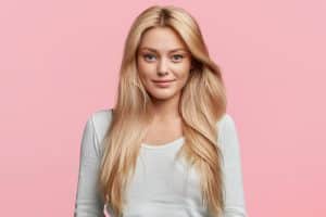 Immagine di una giovane donna con capelli biondi e sorriso naturale.