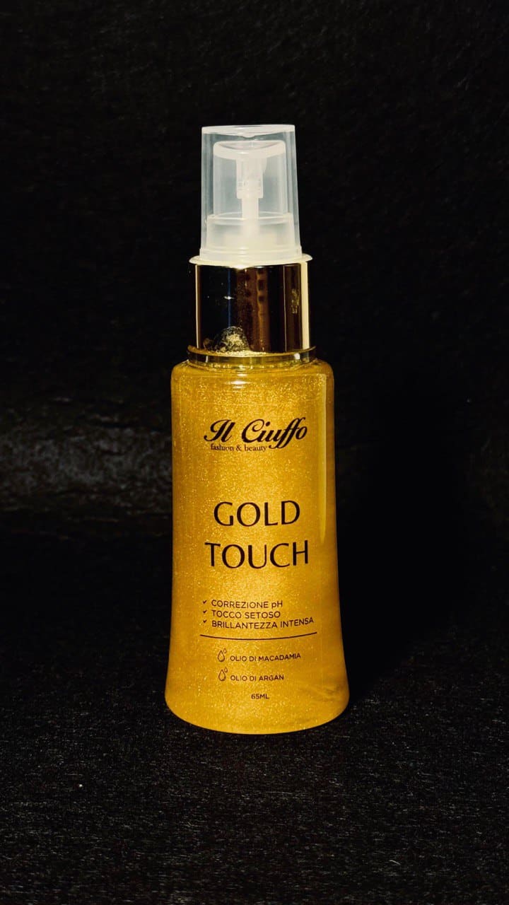 Siero illuminante oro Touch in bottiglia con spray, ideale per pelle luminosa.
